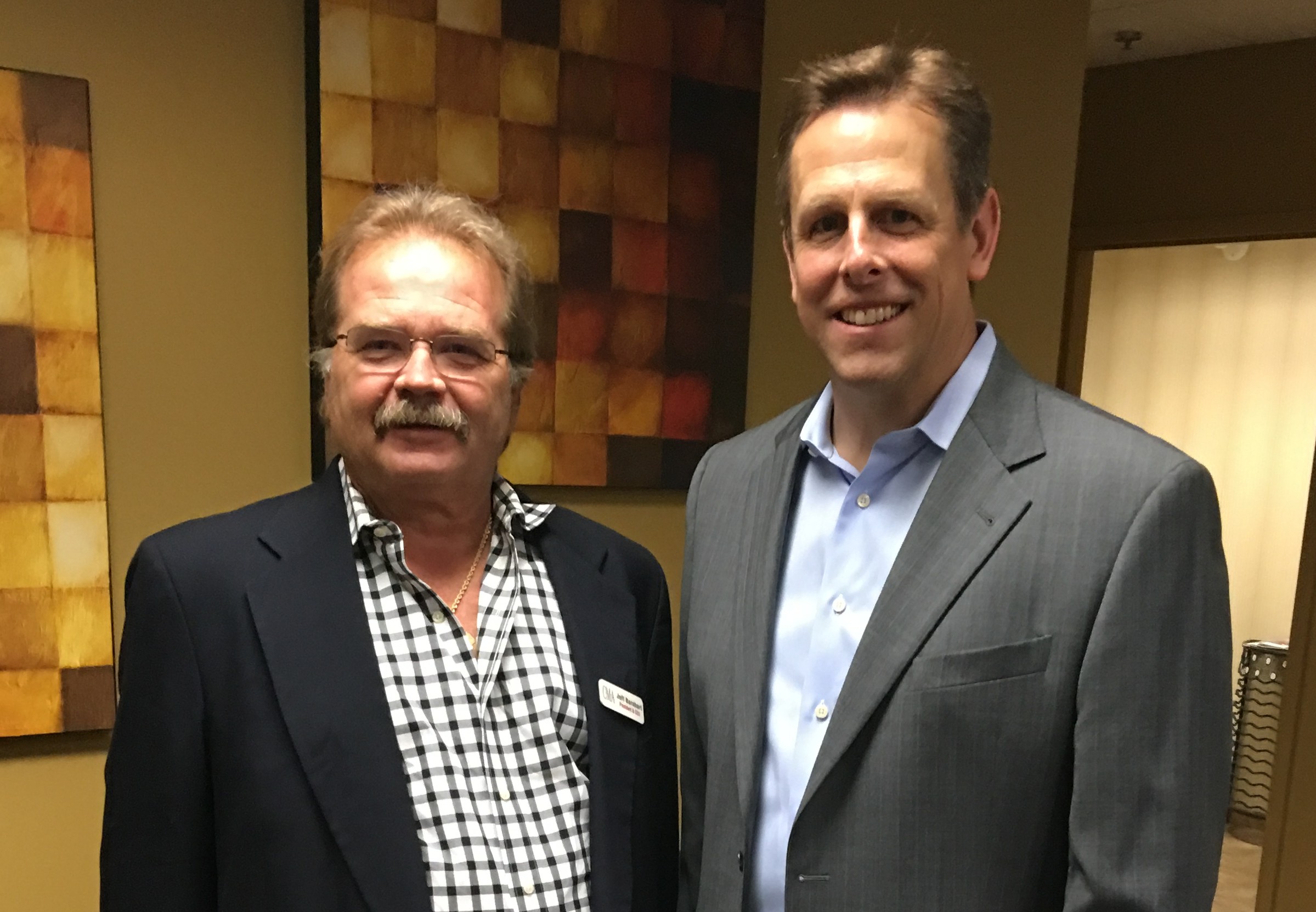 Jeffrey Barnhart, CEO and president of CMA and Robert Hogg, executive director of Ancero at the wine tasting to benefit Trenton Digital Initiative at the IT consulting company’s office in Mount Laurel.