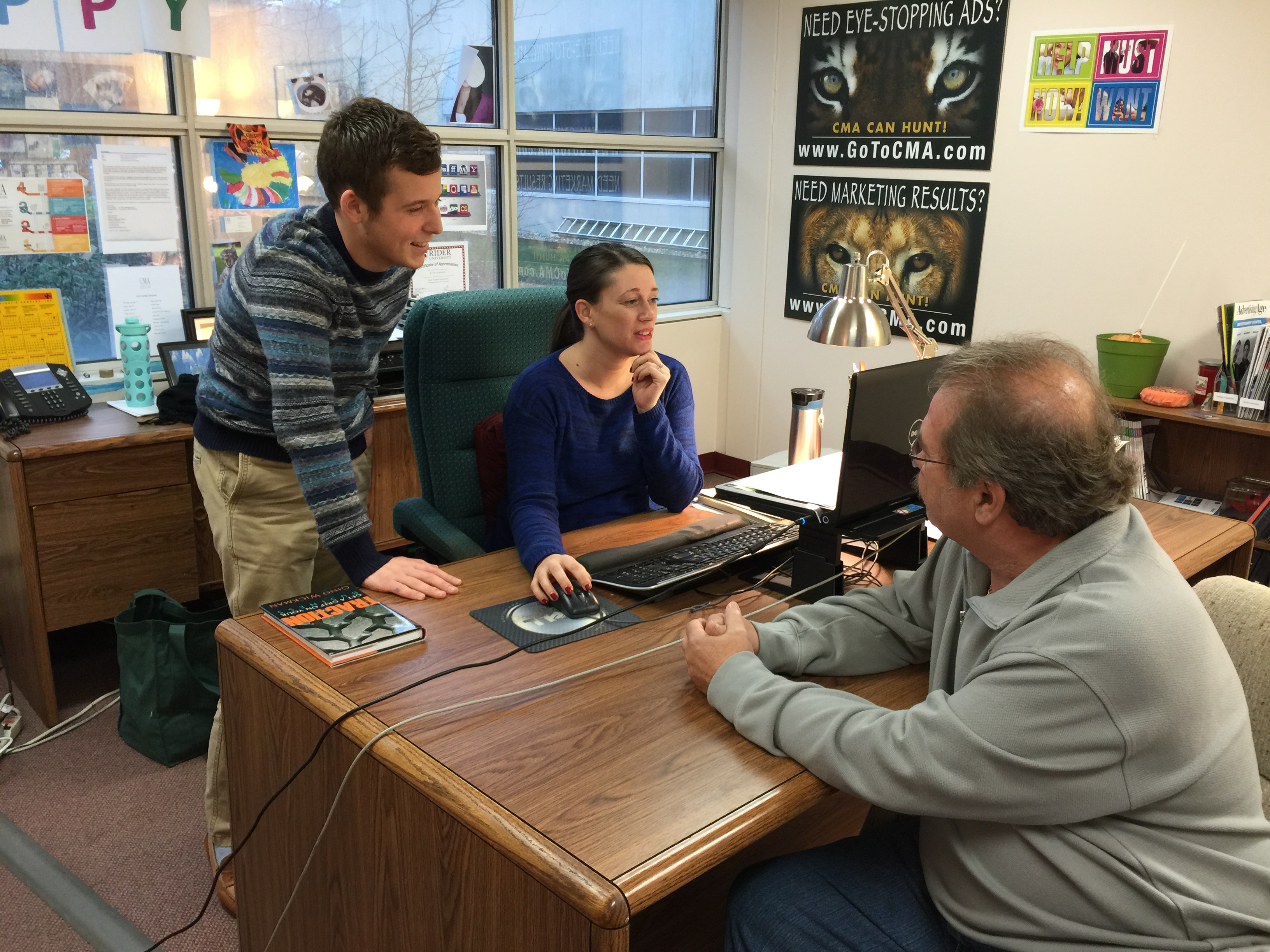 Kevin Grunder, a public relations major at Rider University who lives in Linden, works with Erin Klebaur, director of marketing services, and Jeff Barnhart, CEO and president, as he gets ready to present his ideas for the CMA blog to the management team as part of his internship at Creative Marketing Alliance.