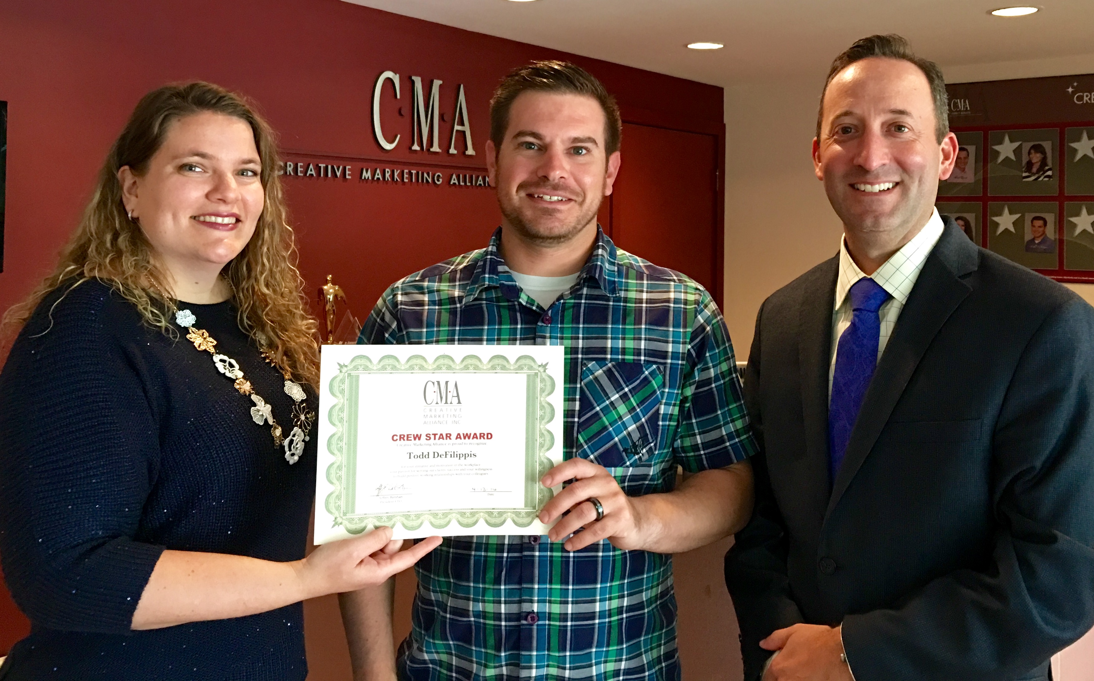 Victoria Hurley-Schubert, public relations and social media specialist and first quarter Crew Star (left) and Christian Amato, COO (right) present Todd DeFilippis, senior accountant (center) the Crew Star award for the second quarter.