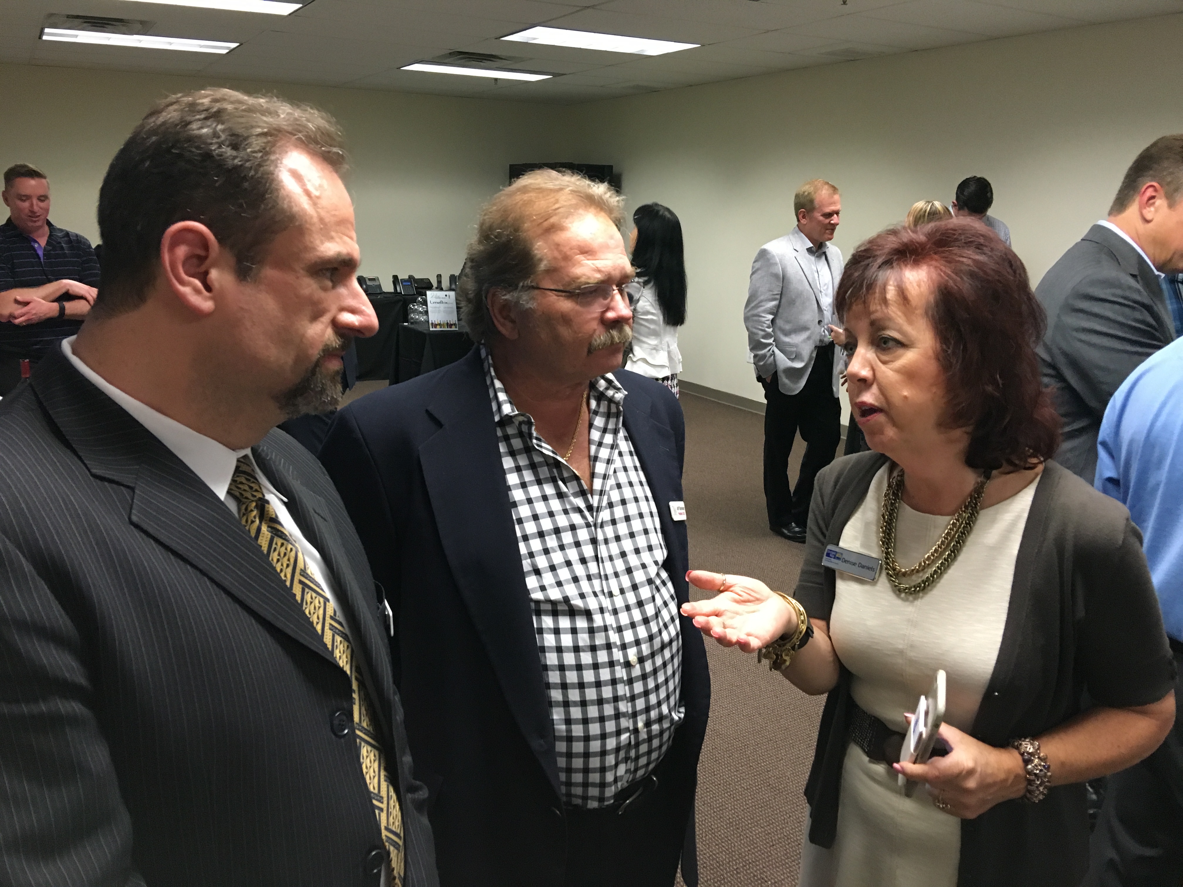 Kenneth Hitchner, director of public relations and social media at CMA, Jeffrey Barnhart, CEO and president of CMA speak with Denise Daniels, director of community outreach and volunteer services at United Way of Greater Mercer County at a wine tasting to benefit Trenton Digital Initiative at Ancero in Mount Laurel.
